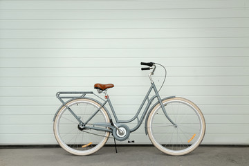 Fototapeta na wymiar Retro bicycle near white wall
