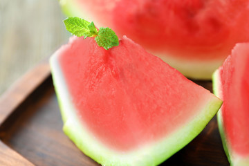 Tasty sliced watermelon on wooden board, closeup