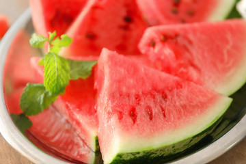 Plate with tasty sliced watermelon on table, closeup