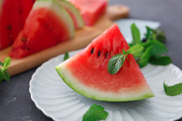 Plate with slice of tasty watermelon on table