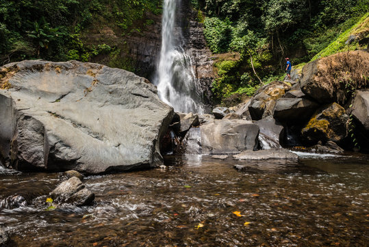 mountain river in the foreground and a waterfall in the back