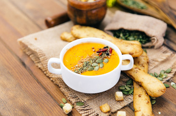 Vegetarian pumpkin soup in white bowl