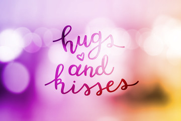 hugs and kisses, lettering, vector handwritten text on blurred lights
