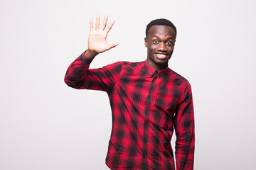 Fototapeta premium Positive human emotions, facial expressions, feelings, attitude and reaction. Friendly-looking polite young African American man saying hi, waving his hand