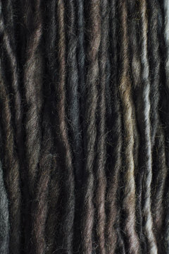 Close up detail of grey and earth tone wool yarn