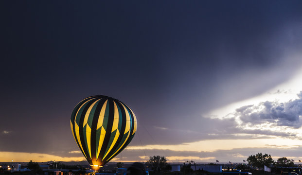 Hot air balloon glows in a stormy weather