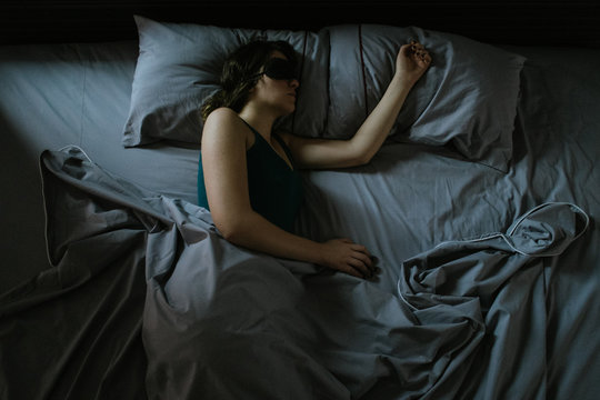 Young woman sleeping in bed
