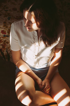 Girl Sitting in Light