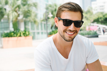 Portrait of a smiling young man with sunglasses
