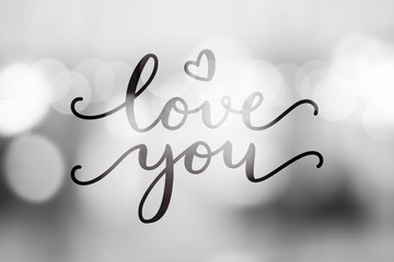 love you, vector lettering on blurred lights background, valentine card template