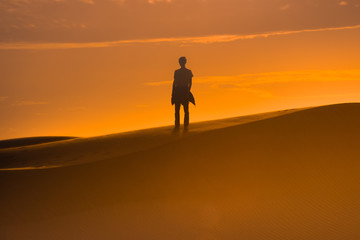 Fototapeta na wymiar Two human silhouette in the sand desert 