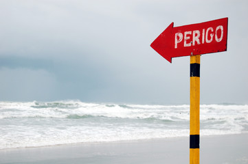 Beach sign on a cloudy day - Danger!