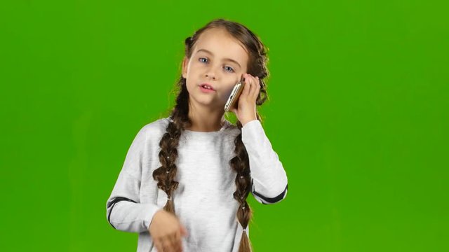 Child is on the phone. Green screen