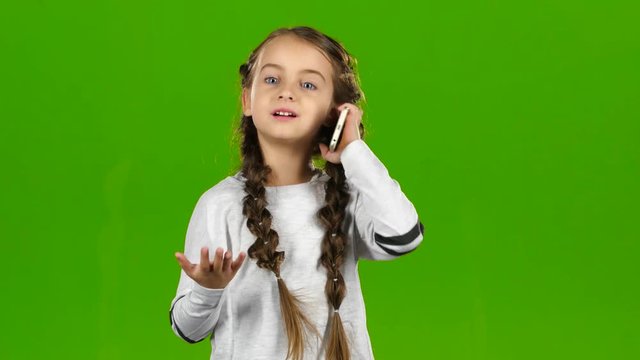 Kid is on the phone. Green screen