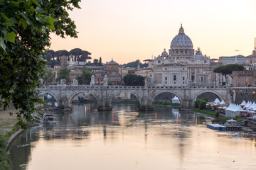 Fototapeta na wymiar ROME, ITALY - JUNE 22, 2017: Amazing Sunset view of Tiber River, St. Angelo Bridge and St. Peter's Basilica in Rome, Italy