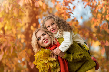 happy young family having fun in autumn park