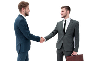 Two businessmen making agreement, their colleagues standing near