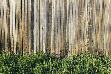 Detail of wood fence and green grass