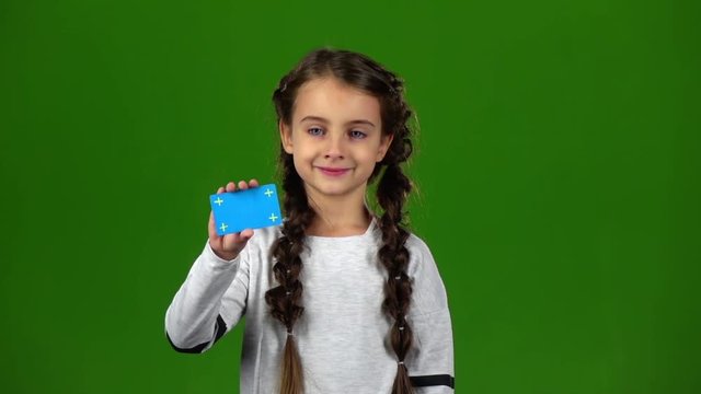 Baby shows an empty card. Green screen. Slow motion