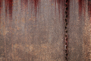 Bloody background scary old rusty chains hanging on rusted steel wall, concept of horror and...