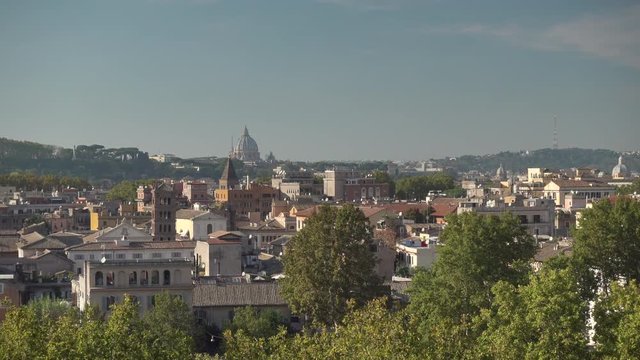 Amazing view of the city of Rome seen from the Orange Garden (Giardino degli Aranci). The dome of Saint Peter Basilica in the Background. Rome, Italy.