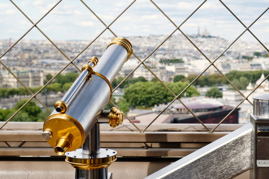 Vintage telescope looking at Paris from the Eiffel Tower