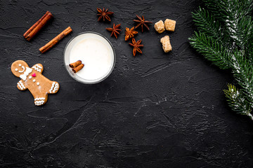 christmas drink cooking eggnog in glasses for celebration with cinnamon and spruce black table background flat lay mock-up