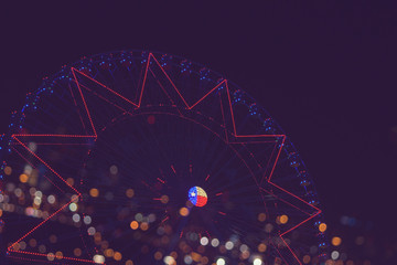 bokeh lights in the background of ferris wheel at night , filtered tones