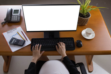 Close-up of pregnant woman belly  with laptop computer on wooden table ,blank screen laptop computer.