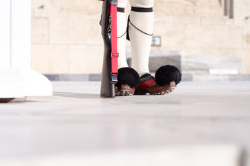 Tsolias or known as Evzones is Greeces historic presidential guard Syntagma.Tsarouhi is a type of shoe, which is typically known as part of the traditional uniform by the Greek guards