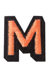 Capitol letter M of stitched with thread. Isolate on white background