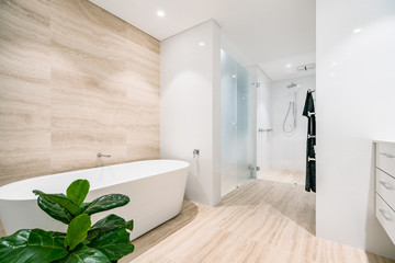 Interior of a white, light coloured bathroom in a modern Australian home.