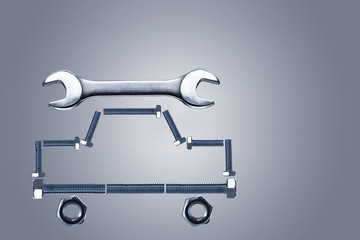 Образ автомобиля из металлических болтов и гаечный ключ.Концепция ремонта автомобиля.