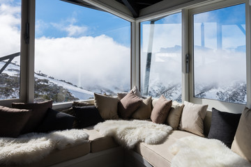 interior of alpine chalet looking over mountains - obrazy, fototapety, plakaty