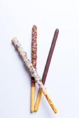 Chocolate dipped biscuit sticks on white background