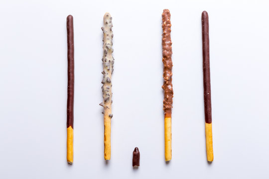 Chocolate dipped biscuit sticks on white background