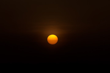 Big sun in the dark background.