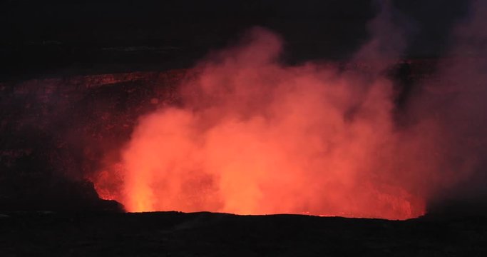 Kilauea Volcano night lava glow smoke from crater Hawaii National Park. Most active volcano in the USA. Smoke, steam, gasses. Big Island in Volcano National Park. Tourism destination for science.