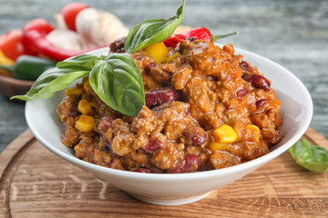 Plate with chili con carne on table