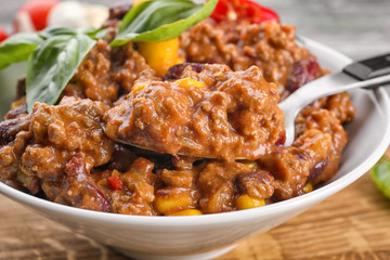 Plate with chili con carne on table, closeup