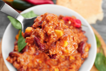 Chili con carne in spoon, closeup