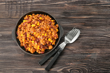 Chili con carne in frying pan on table