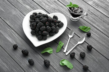 Composition with delicious ripe blackberries on wooden background