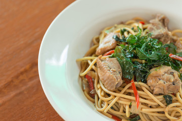 Close up, Spaghetti with chicken and basil crispy.