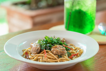 Spaghetti with chicken and basil crispy. Selective focus.