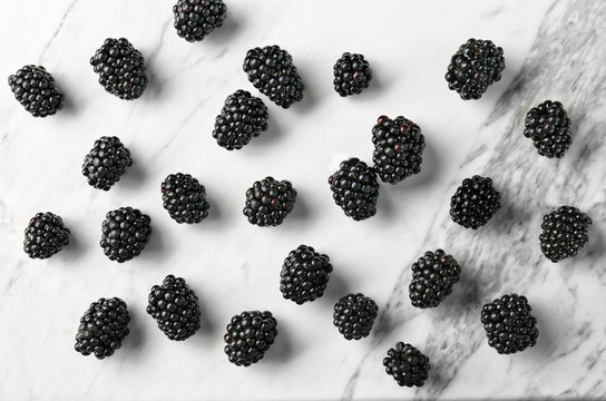 Delicious ripe blackberries on light background