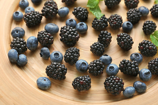 Closeup of ripe blueberries and blackberries on plate