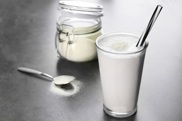Glass with protein shake on table
