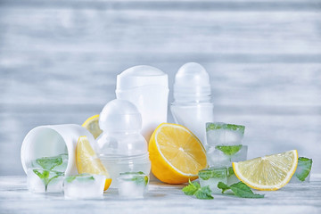 Deodorants for women, lemons and mint on table