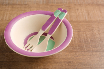 Bright baby dishware on table